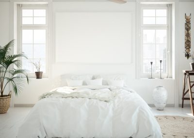bedroom with white walls and bad with white bedspread