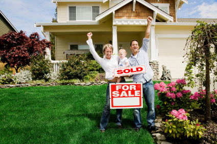 Family with Sold Sign at Home